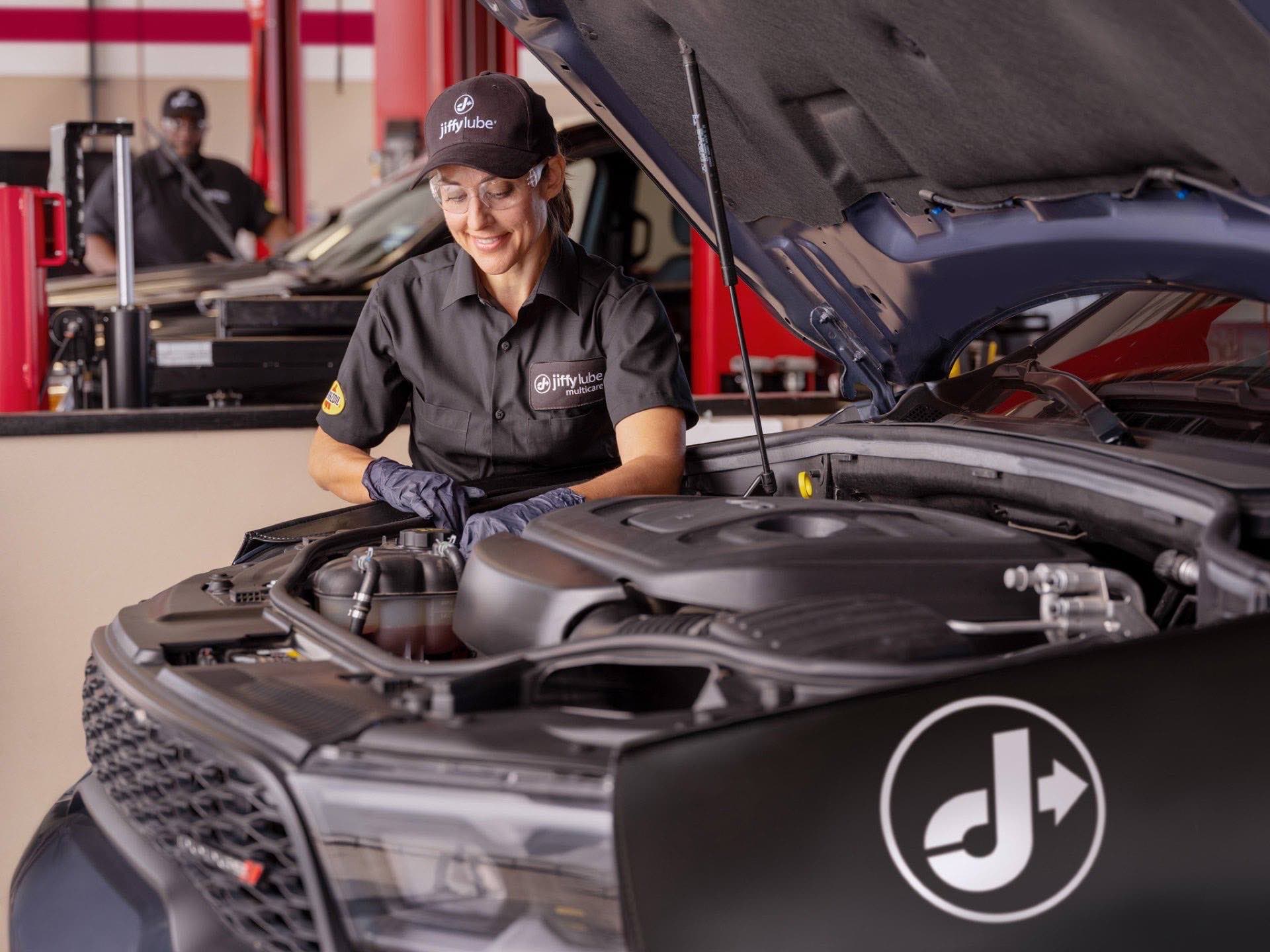 A Jiffy Lube technician performing a Signature Service oil change in Ocala, Florida