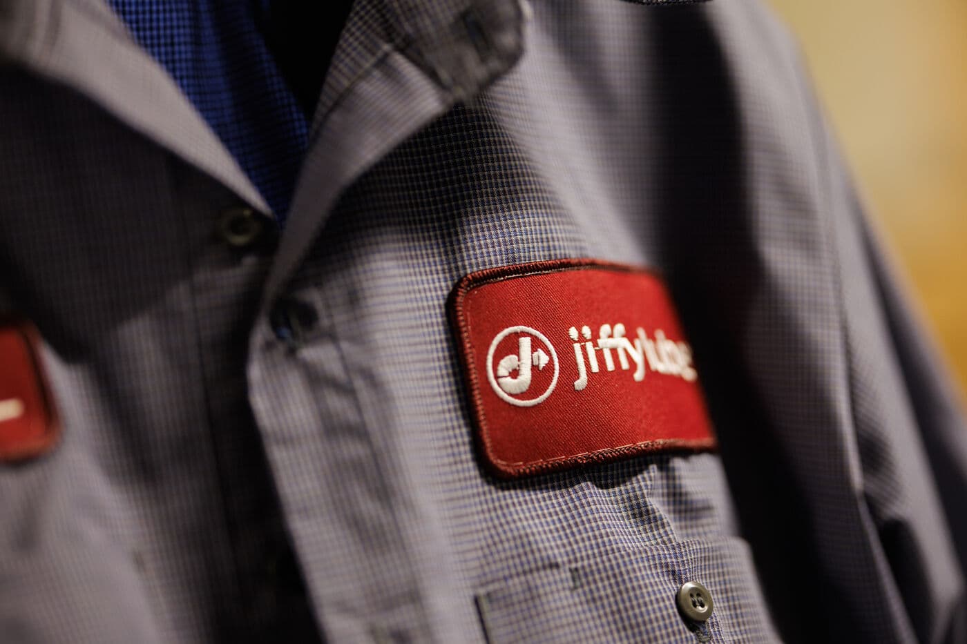 A uniformed Jiffy Lube technician