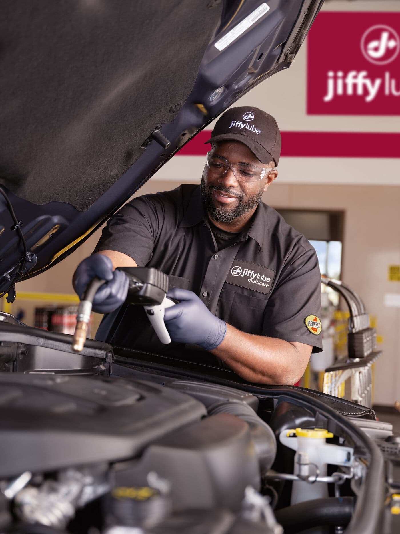 A Jiffy Lube technician servicing a vehicle in the Orlando area